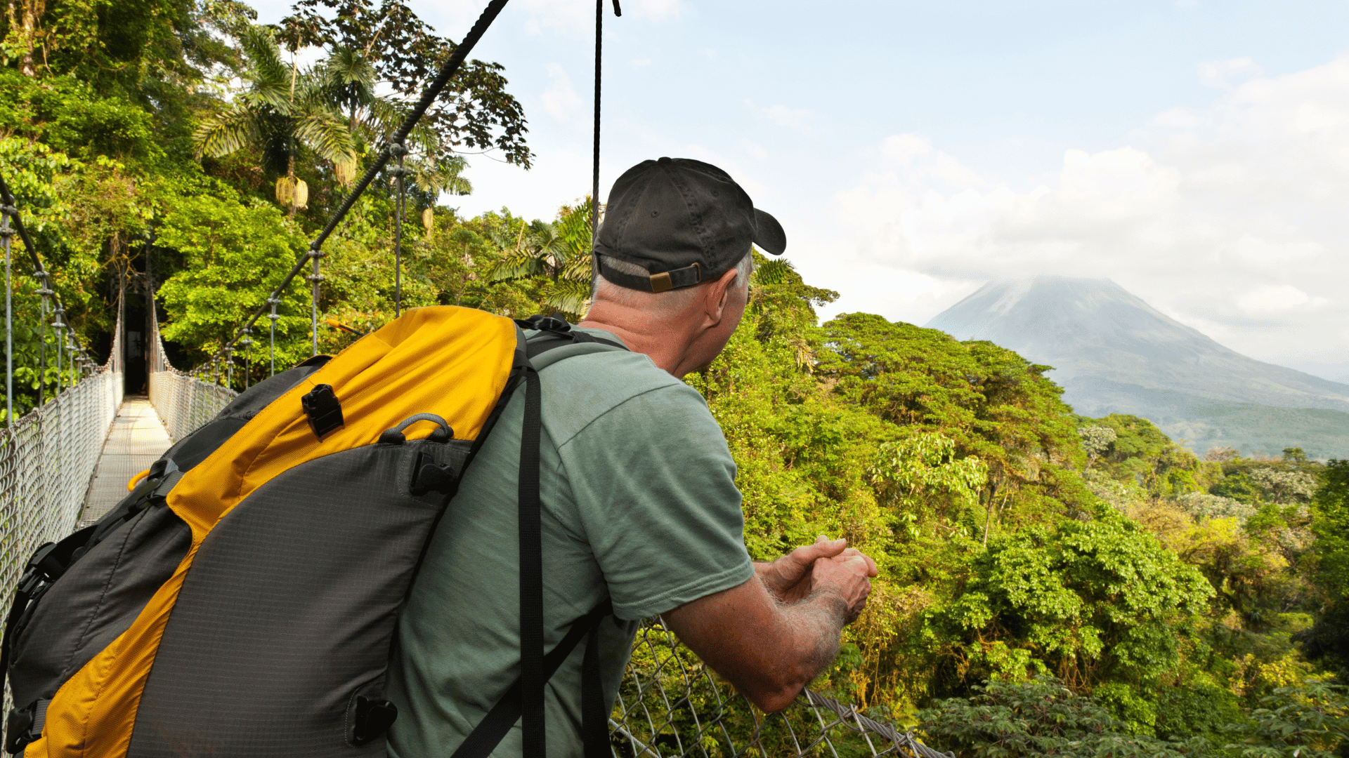 Man hiking in jungle, hanging bridge, Arenal Volcano, Costa Rica