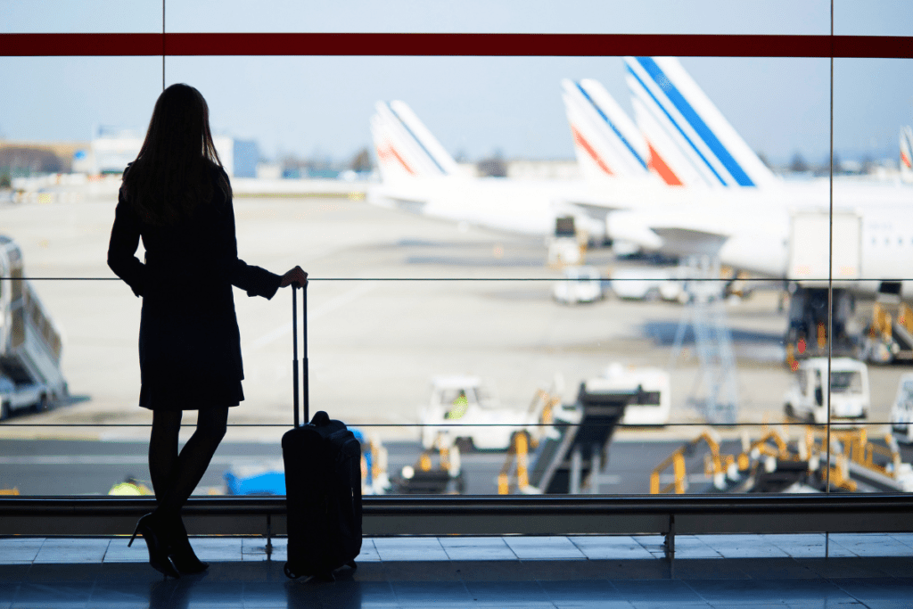 girl holding her luggage in an airport
