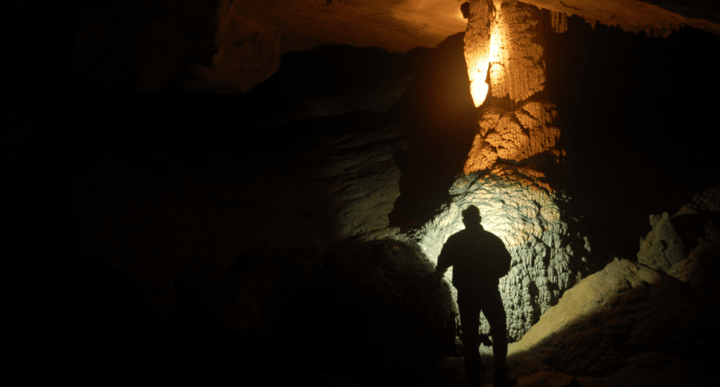 Venado Caves Costa Rica a man standing in a cave