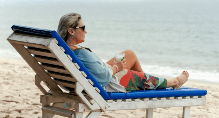 Woman Sitting on a Deckchair at the Beach Green Season Woman Sitting on a Deckchair at the Beach