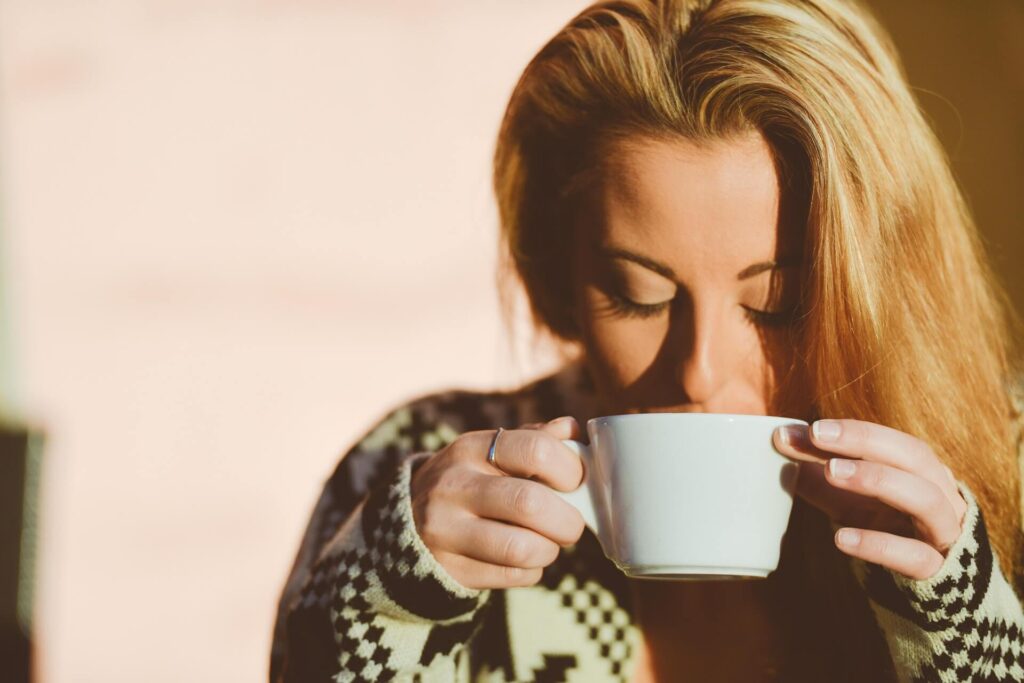 Traveler savoring a fresh cup of Costa Rican coffee, similar to the tasting experience included at the end of La Chimba's coffee tour through their solar-powered Beneficio